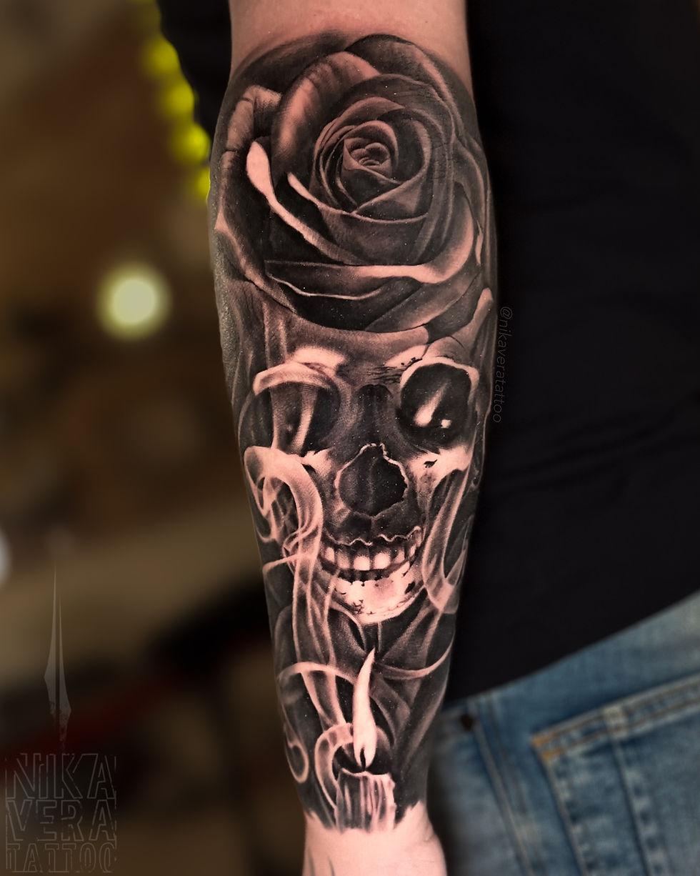 skull and rose in smoke on forearm
