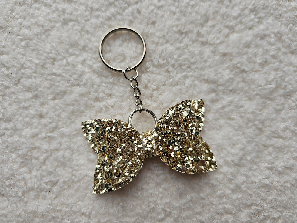 A Gold Chunky Glitter Bow on a Keyring.