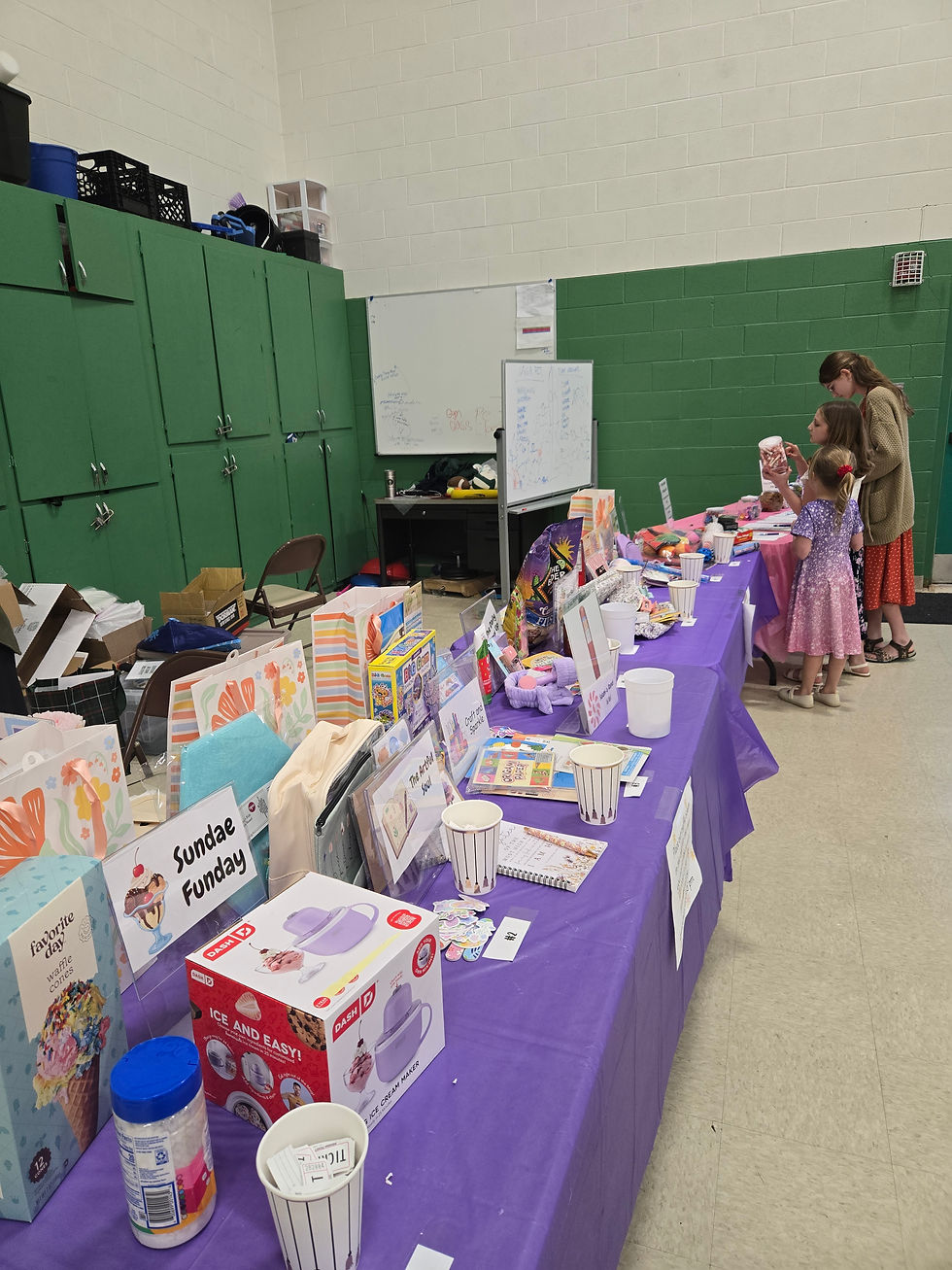 Several girls check out the raffle gift table. Gifts were put together and donated by SPO.