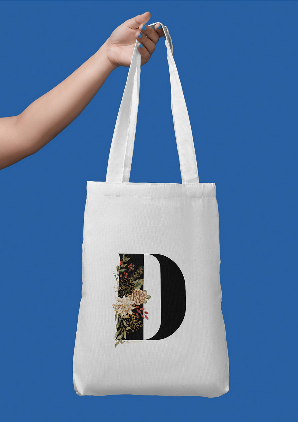 A beautifully designed Christmas theme letter D featuring festive floral elements from SD_DOODLES on a tote bag