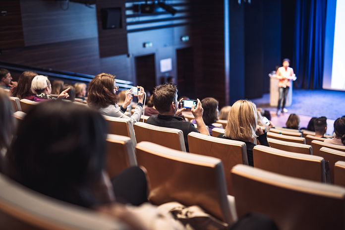 woman-giving-presentation-business-conference-event.jpg