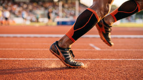 Close-up of a sprinter's foot at the moment of ground contact during maximal-velocity running, illustrating the mechanics of leg stiffness.