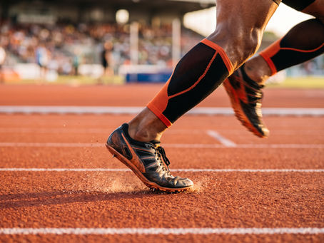 Close-up of a sprinter's foot at the moment of ground contact during maximal-velocity running, illustrating the mechanics of leg stiffness.