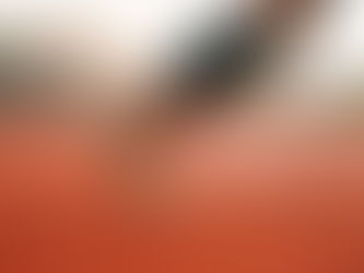 Close-up of a sprinter's bare foot at the instant of push-off on a running track, weight driving through the forefoot and big toe.