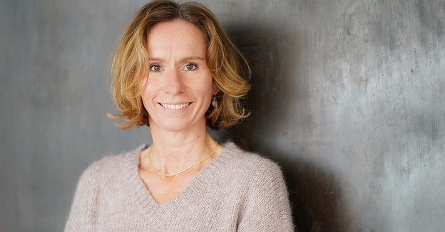 Outdoor Businessfoto einer sympathischen Frau vor Stahlmauer