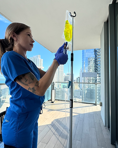 A Key Basis IV nurse preparing an IV drip on a high rise balcony