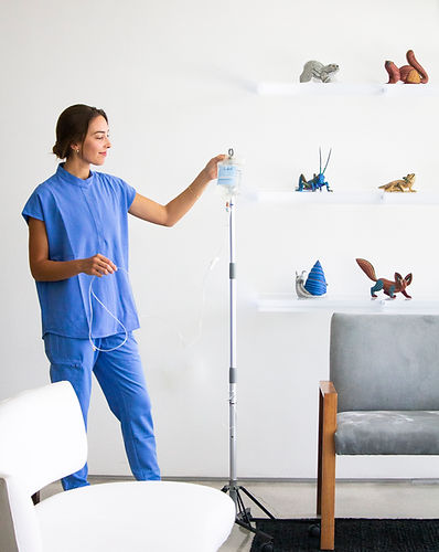 A Key Basis IV nurse preparing an IV drip
