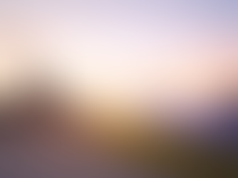 Solar panels generating renewable energy in a field at sunrise, with industrial smokestacks and cooling towers emitting smoke in the background.