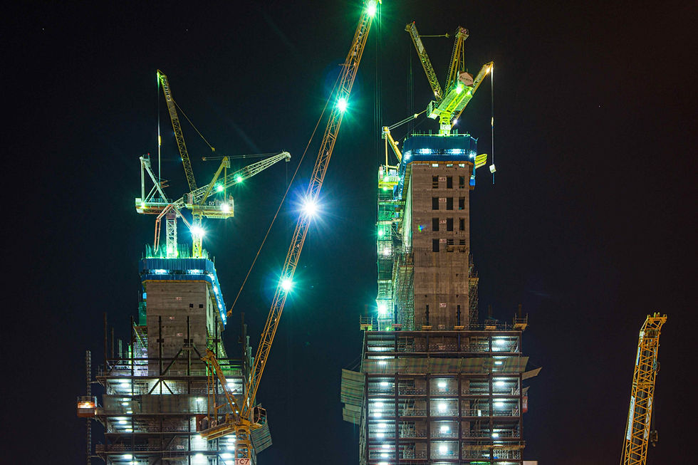 Lighting towers illuminating an active night construction project in Malaysia