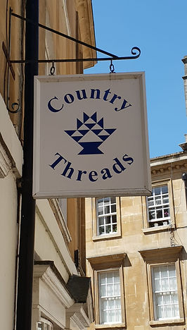Country Threads logo on board outside the quilting shop in Bath, England