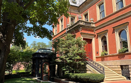 Historic Boston townhouse with red-brick facade, landscaped garden and architectural detailing
