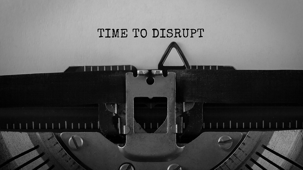 Close-up of a typewriter with paper displaying "TIME TO DISRUPT" in bold, black letters. Mood suggests disruption and change.