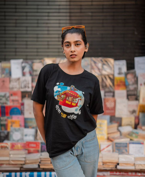 Woman in black graphic T-shirt at a book market