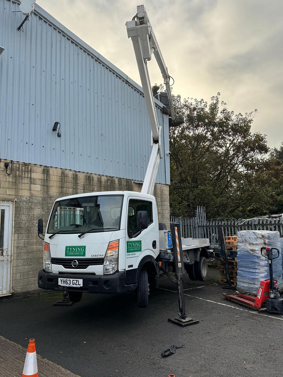Tyning Landscapes cherry picker gutter clearing a commercial building