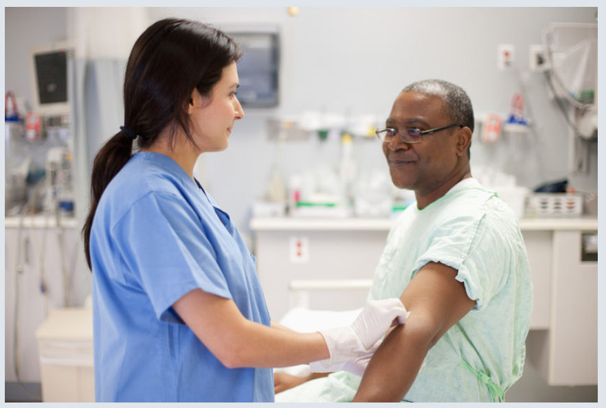 NHS Nurses preparing a patients arm for an injection
