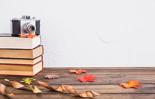 dried-leaves-near-books-camera