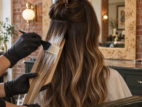 Balayage in Pittsburgh: colorist hand-painting balayage on long brunette hair at Aura Hair Studio
