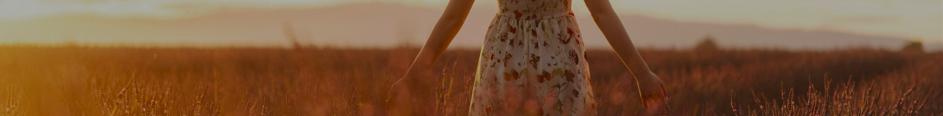 Woman walking through field symbolising menopause support and wellbeing
