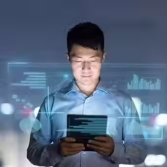Entrepreneur using a digital tablet surrounded by AI interface, representing how A.R.T.I. supports business leaders with real-time insights, forecasting, and ethical automation.