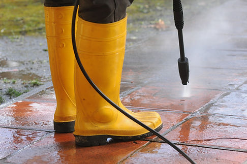 persona-vestida-botas-goma-amarilla-boquilla-agua-alta-presion-limpiando-suciedad-baldosas