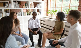 African man speaking at group counseling