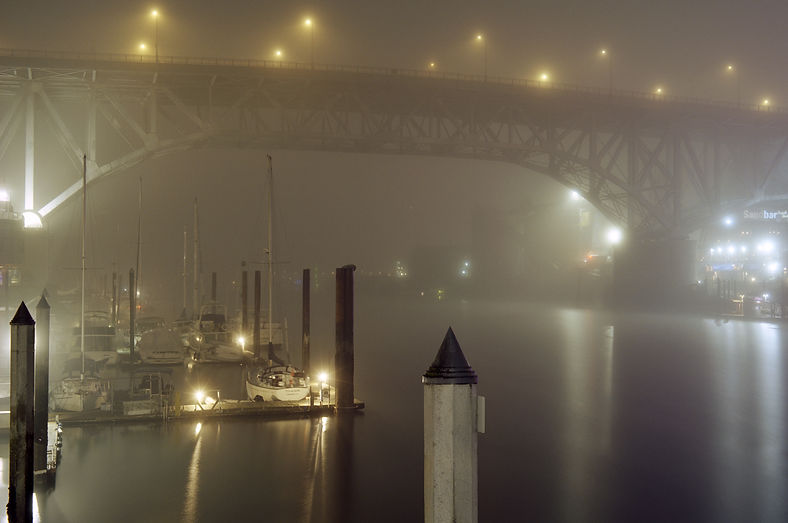 Thick fog blankets False Creek under the Granville Bridge in Vancouver Canada