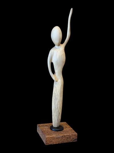 Abstract sculpture of a dancer made of pine and exotic woods.