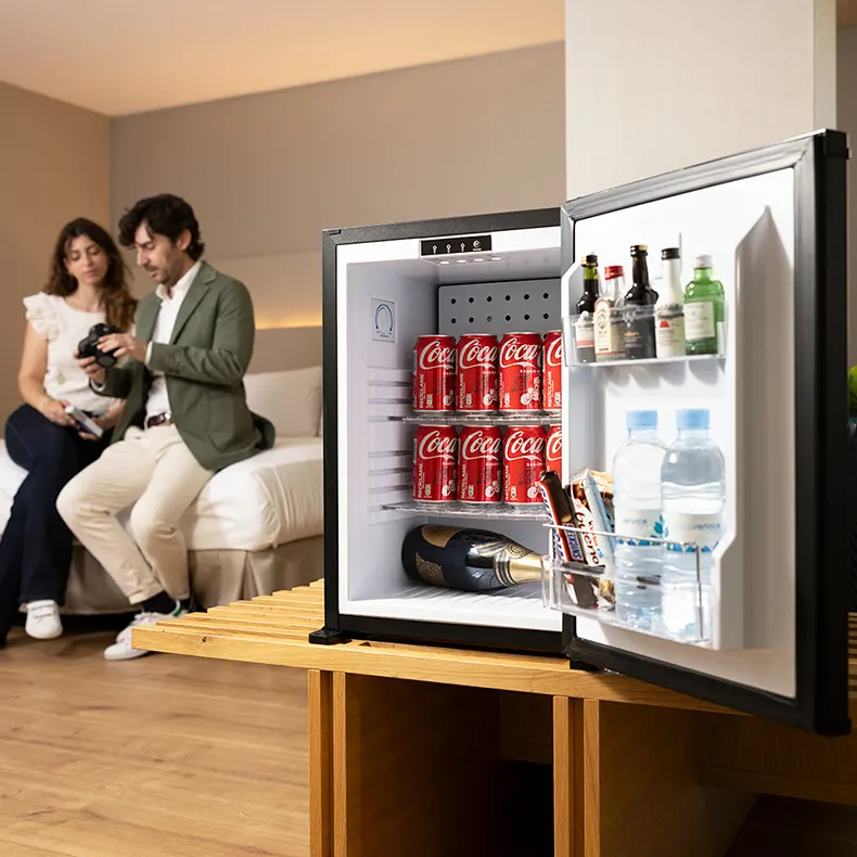 Couple opening minibar in a well-appointed hotel room