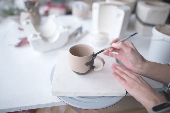 Woman Painting Pottery