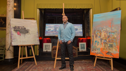 Mo Negm with his paintings
