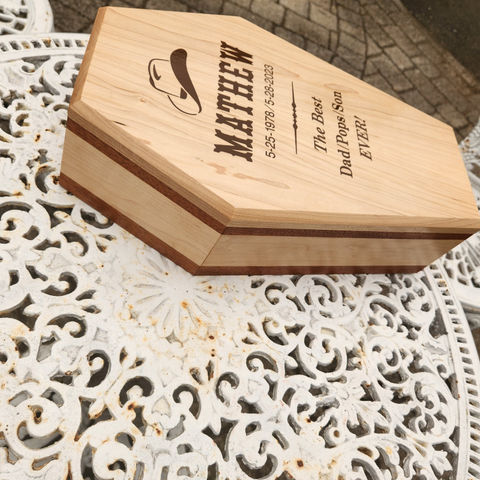 Handcrafted wooden urn with personalized details.