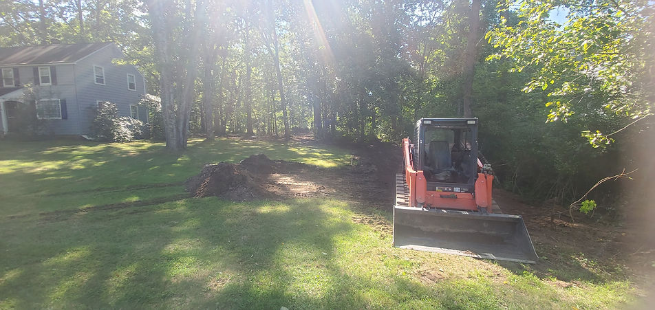 Kubota Excavator on the side of the house.