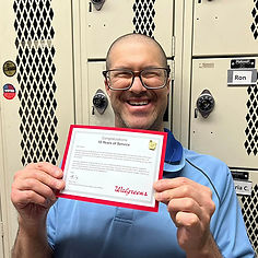 Jason showing his 10 Years of Service Certificate from Walgreens