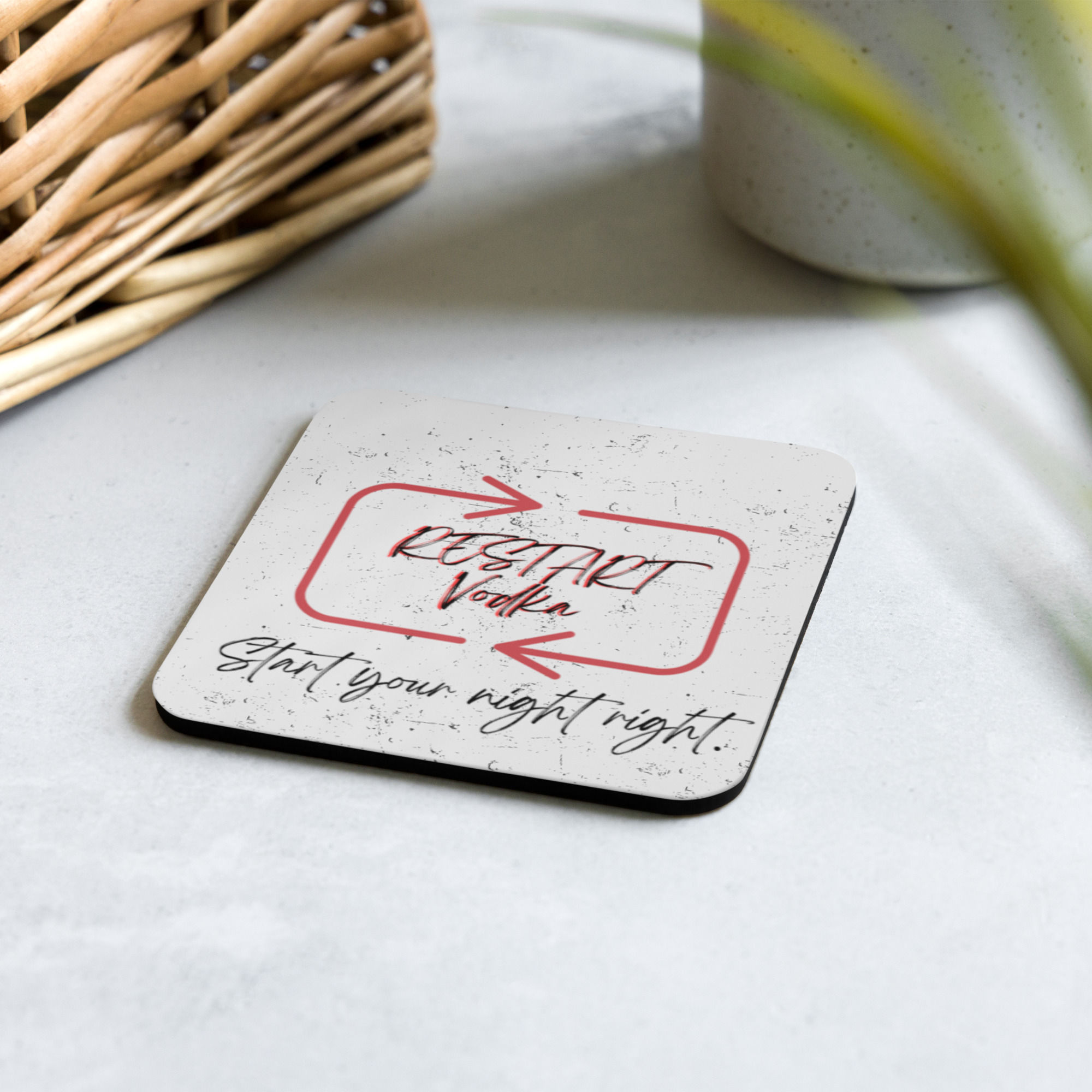 Restart Vodka cork-back coaster on a table.