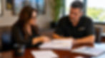 Construction bookkeeper presenting monthly WIP schedule to contractor owner