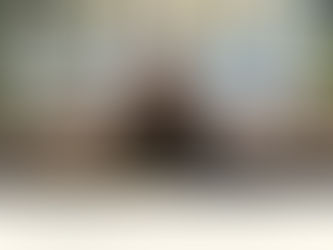 Construction bookkeeper reviewing Procore and Sage 100 Contractor data on dual monitors in Orange County California office