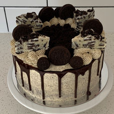 Two layer chocolate cake filled with oreos, chocolate ganache and oreo buttercream, topped with Oreos