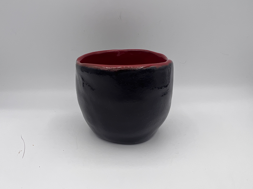 black pinch pot with red glaze