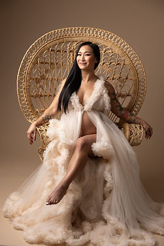Pregnancy photoshoot of our physio Doris, sitting on a throne