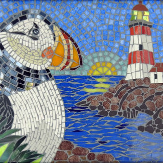 The puffin’s bright beak and expressive stance stand in contrast to the rugged coastline, lighthouse, and rising sun beyond.