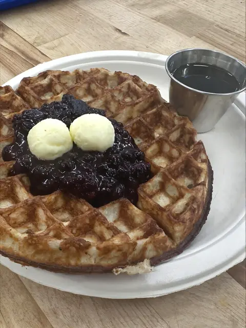 waffle with butter, maple syrup and blueberry compote