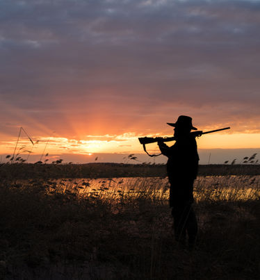 Hunter carrying a rifle