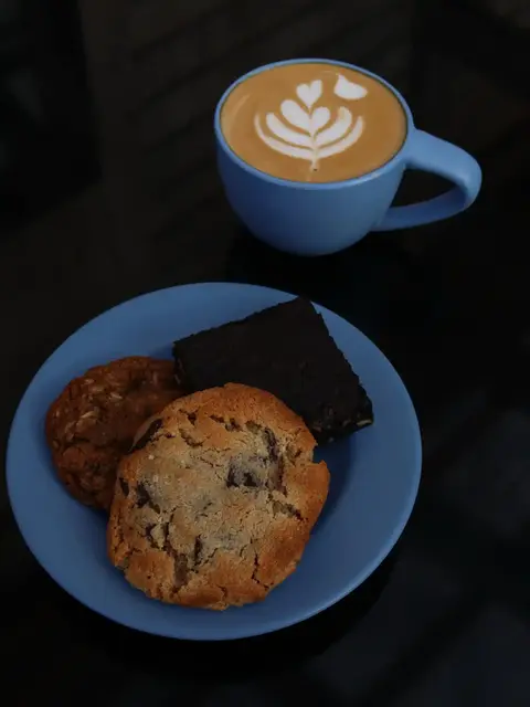 coffee drink in a mug with a plate of cookies