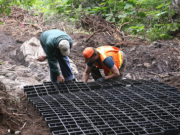 two men working on a trail