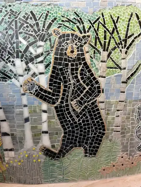 mosiac depicting a black bear in a woodland scene