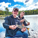 Two fishermen with their catch