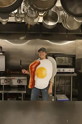 restaurant employee wearing a bacong and egg costume
