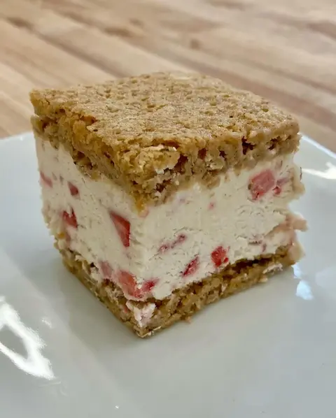 a slice of strawberry-filled dessert