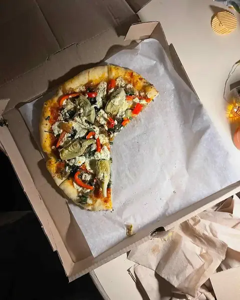 half-eaten pizza in a box