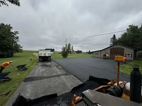 applying new asphalt to pave a road